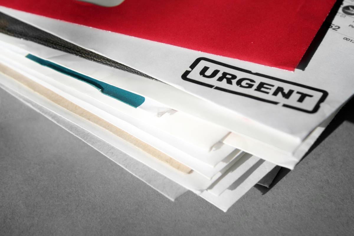 Sales team reviewing B2B direct mail prospecting campaign with branded packages and metrics